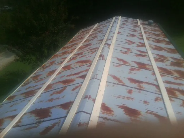 Rusted metal roof panels with new wood purlins before replacement — Storm Damage Roof Repair in Middletown by Roofing Brothers